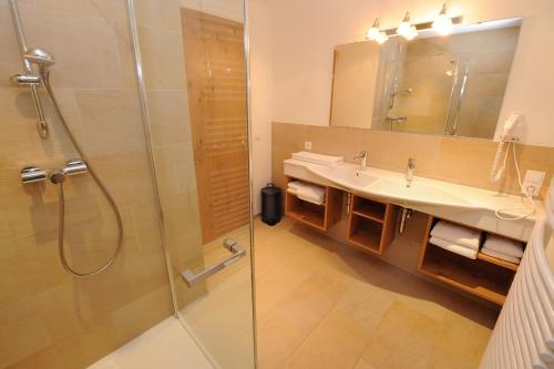a bathroom with a sink and a shower at Landhaus Berthold in Gargellen
