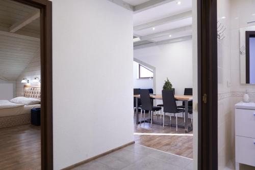 a living room with a table and a dining room at Villa Gor Apartments in Bukovel