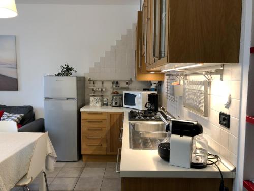 a kitchen with a sink and a refrigerator at Cadillac apartment in Venice