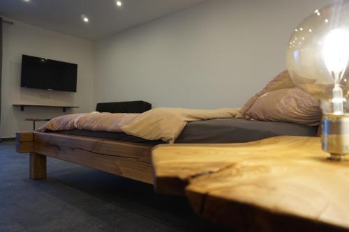 a bedroom with a bed and a flat screen tv at Wohnung 1 im Kirschblütenhof in Ingelheim am Rhein