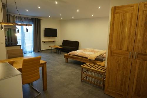 a bedroom with a bed and a living room at Wohnung 1 im Kirschblütenhof in Ingelheim am Rhein