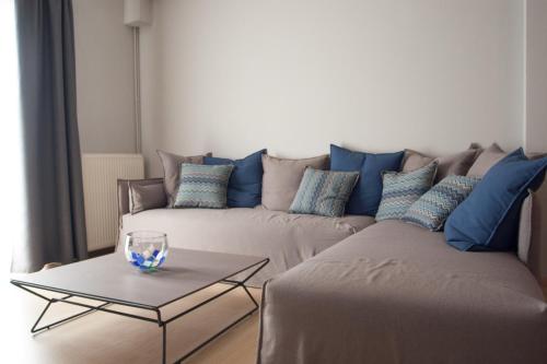 a living room with a couch and a table at Stylish Zoi's appartment next to HELEXPO, White Tower in Thessaloniki