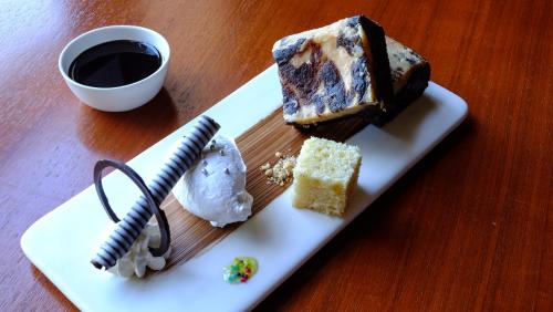 a plate with a piece of cake on a table at Sea Shell Resort & Spa, Havelock in Havelock Island