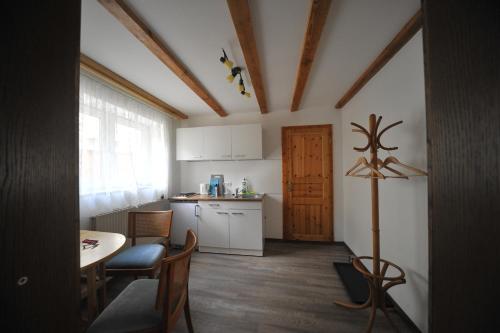 a small kitchen with a table and chairs and a door at Old town center apartments on the Romantic Road in Harburg