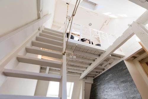 a staircase in a room with white ceilings at Y & L villa in Antwerp
