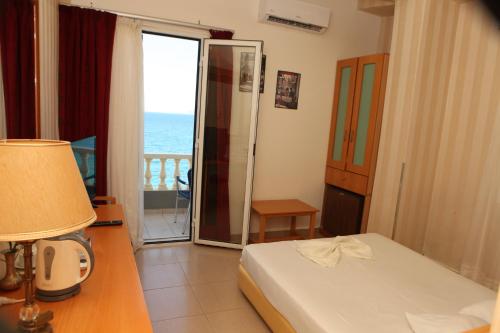a bedroom with a bed and a view of the ocean at Seaside Hotel in Loutraki