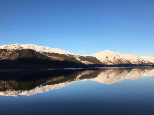 a view of a lake with mountains in the background at Outlander Glencoe at Creag an-t Sionnaich Glencoe Ballachulish Highlands Near Fort William in Glencoe