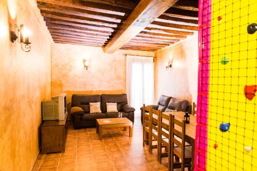 a living room with two couches and a table at Casa Rural Tio Mora in Horche