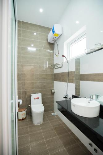 a bathroom with a sink and a toilet at Mỹ Kim Villa in Da Lat