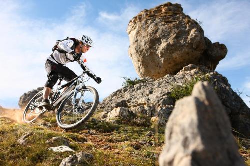 a man riding a bike on a rocky trail at Blu Hostal Diana in Port d'Alcudia