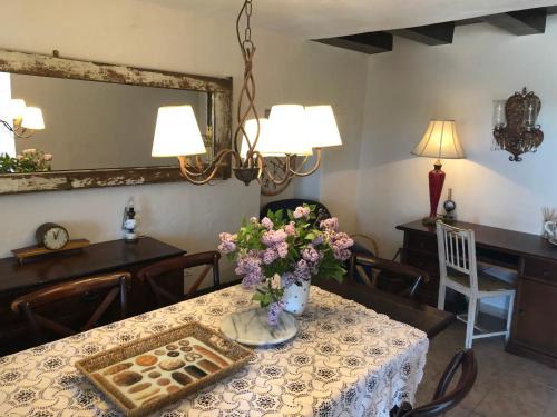 a dining room with a table with a vase of flowers at panoramic sea view house in Tučepi