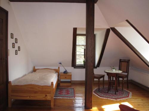 a bedroom with a bed and a table and a window at Ferienwohnung mit tollem Ausblick in Dresden