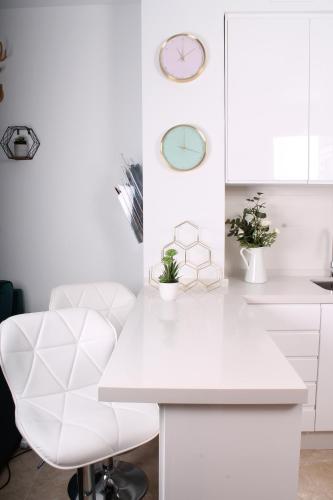 een witte keuken met een wit bureau en een witte stoel bij Ancha del Carmen AVE Centro Málaga madmar lujo New Zambrano in Málaga