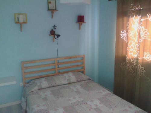 1 dormitorio con 1 cama y una ventana con cruces en la pared en Casa do Baixio, en Faja Grande