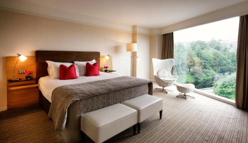 a hotel room with a bed and a large window at The River Lee Hotel a member of The Doyle Collection in Cork