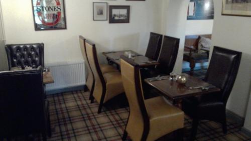 a dining room with tables and chairs in a restaurant at The Masons Arms in Harrogate