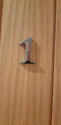 a metal number on top of a wooden table at The Masons Arms in Harrogate