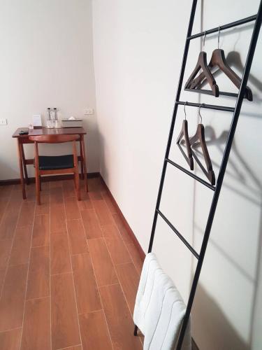 a room with a table and a shelf with shoes at A Day inn Ranong Hostel in Ranong
