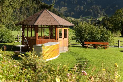 a small gazebo in a field with a bench at Landhaus Rohrmoser in Werfenweng