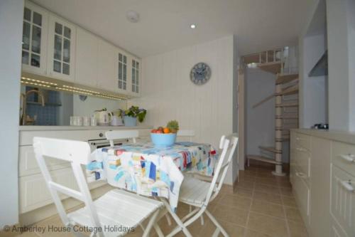 a kitchen with a table and chairs in a kitchen at Tackleway Cottage in Hastings