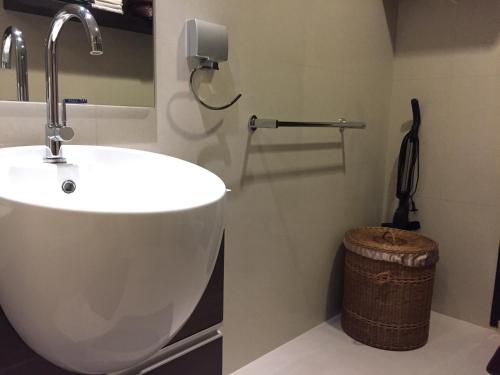 a bathroom with a sink and a trash can at OV Residence in Bangkok