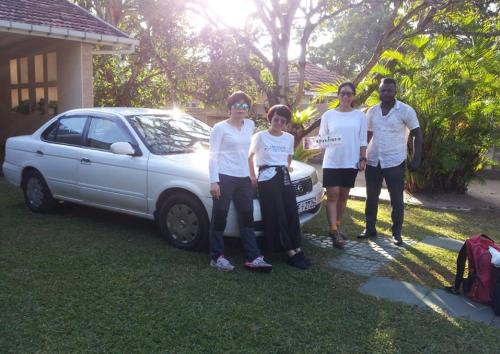 a group of people standing next to a car at Mama's Hostel by Taprobane in Negombo