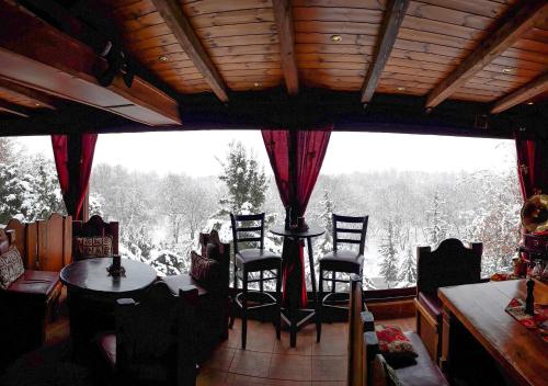 a room with a table and chairs and a large window at Metohi in Marioláta