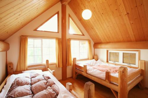 Säng eller sängar i ett rum på Kurokawa Mori no Cottage
