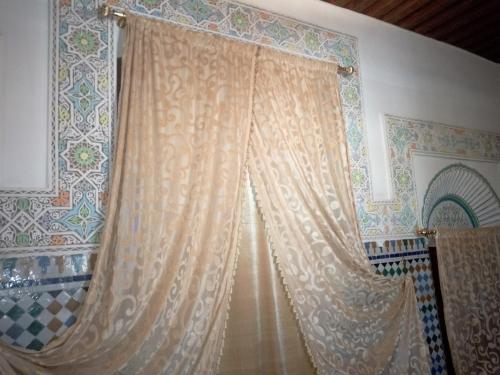 A bed or beds in a room at Riad El Bacha