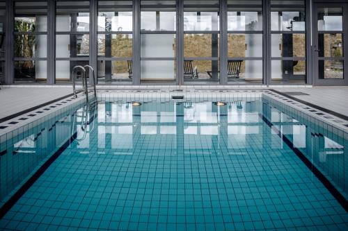 a swimming pool with blue tiles in a building at Fårösunds Fästning in Fårösund