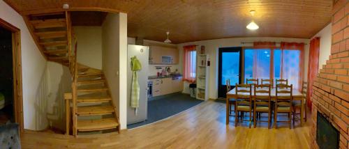 a room with a dining room and a kitchen with a staircase at Les Chalets Fleurs de France - KOTA in Saint-Dalmas