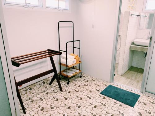 a bathroom with a shower and a sink and a mirror at RiverTree House in Nong Khai
