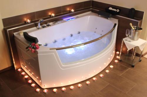 a jacuzzi tub with lights in a room at Residence Dobrovského in Prague