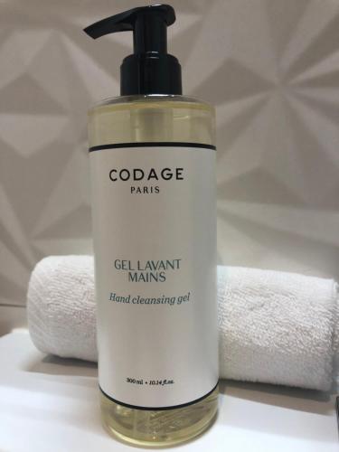 a bottle of soap sitting next to a towel at Gîte Wellness Le Six H in Andolsheim
