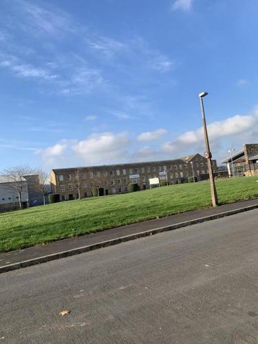 a building on the side of a road next to a street at Entire B&B in Burnley