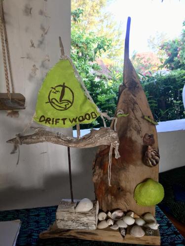 a drift wood house with a sign on it at Driftwood Beach Lodge in Jambiani