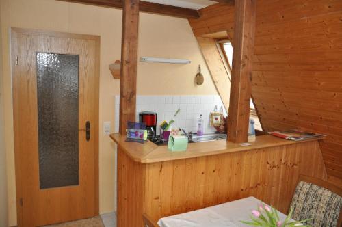 a kitchen with a counter and a door in a room at Ferienwohnung Neubert in Wolkenstein