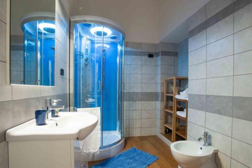 uma casa de banho com um chuveiro azul e um lavatório. em B&B L'Albero Dei Limoni em Portoscuso