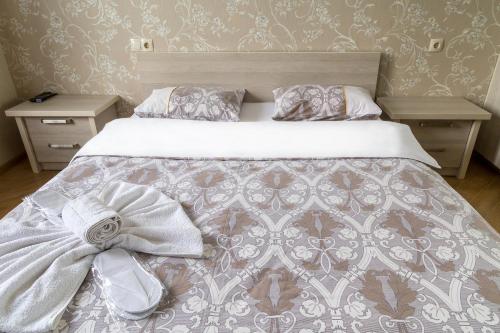 a bedroom with a bed with a bow on it at Tbilisi Comfort Apartment in Tbilisi City