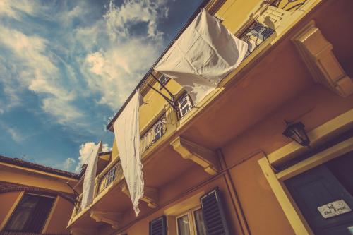 a yellow building with a balcony and a sky at Agriturismo I Surì Asti in Asti