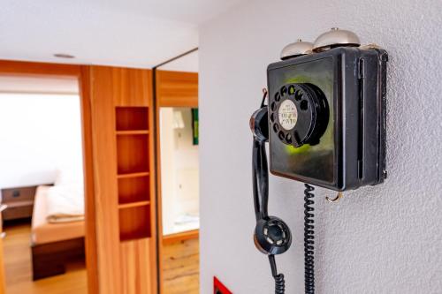 a telephone hanging on a wall in a room at Appartement Binna in Termen