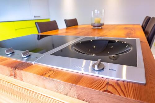 a wooden table with a plate on top of it at Appartement Binna in Termen