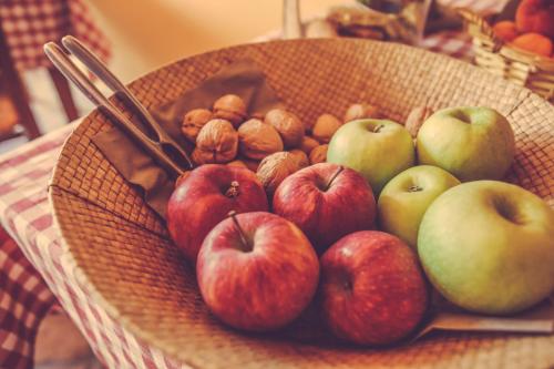 a basket of apples and nuts on a table at Agriturismo I Surì Asti in Asti