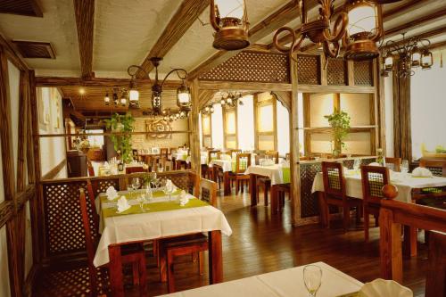 a dining room with tables and chairs in a restaurant at Hotel Krone in Friesenheim