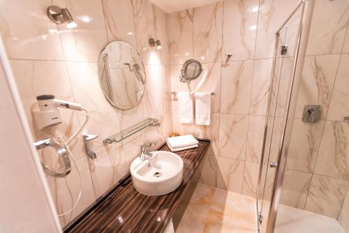 a bathroom with a sink and a shower at Hotel Krone in Friesenheim
