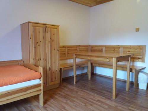 a room with a wooden desk and a table at Penzion Ve Staré škole in Vlastějovice