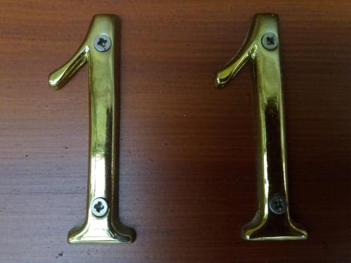 two metal handles on a wooden table at Penzion Ve Staré škole in Vlastějovice