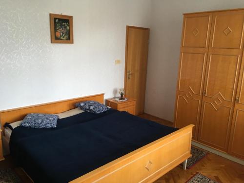 una camera da letto con un letto e un armadio in legno di Vila Černe a Bled