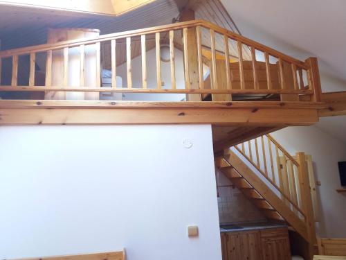 a wooden spiral staircase in a room with at Penzion Ve Staré škole in Vlastějovice