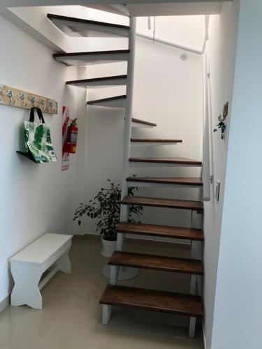 a spiral staircase in a room with a bench at "Ninfas" in Puerto Madryn